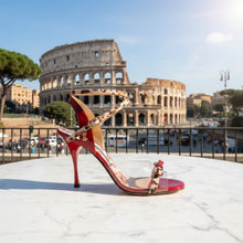 A red  leather high-heeled sandal with leopard-print straps and a clear  Plex toe strap, shown from a side profile on a white background.